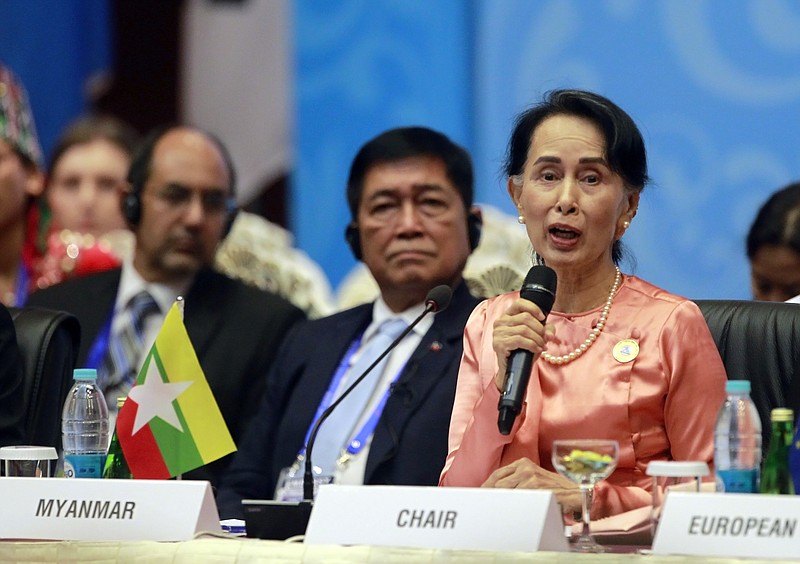 Myanmar Foreign Minister Aung San Suu Kyi, right, speaks during the Asia Europe Foreign Ministers (ASEM) meeting at Myanmar International Convention Centre Monday, Nov. 20, 2017, in Naypyitaw, Myanmar. (AP Photo/Aung Shine Oo)