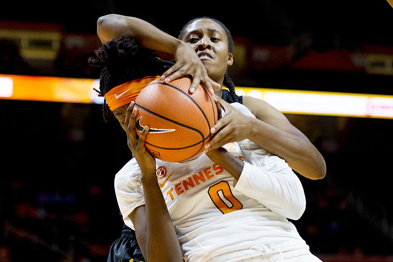 Tennessee's Rennia Davis (0) goes for a layup as Wichita State's Rangie Bessard (35) blocks her shot during an NCAA college basketball game in Knoxville, Tenn., on Monday, Nov. 20, 2017. (Calvin Mattheis/Knoxville News Sentinel via AP)