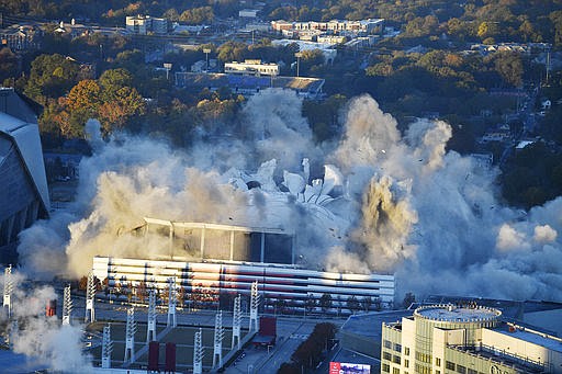 The Georgia Dome is destroyed in a scheduled implosion Monday, Nov. 20, 2017, in Atlanta. The dome was not only the former home of the Atlanta Falcons but also the site of two Super Bowls, 1996 Olympics Games events and NCAA basketball tournaments among other major events. (AP Photo/Mike Stewart)
