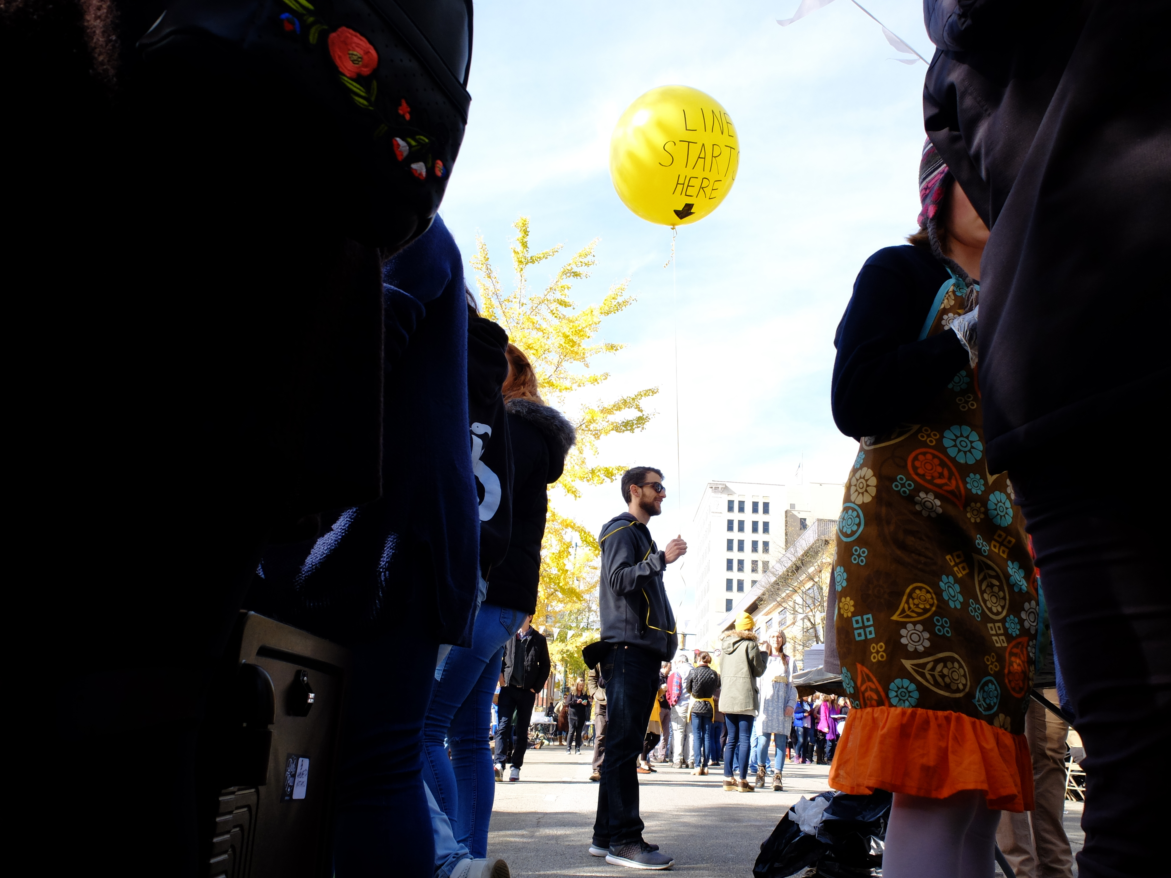 Ooltewah Chiropractor Bryan Stotz holds a balloon to inform attendees of where the food line begins Monday, Nov. 20, on M.L. King Boulevard in front of the Bessie Smith Cultural Center. The event was 1TABLE, Causeway's annual citywide Thanksgiving dinner.