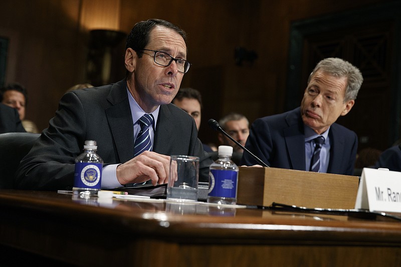 FILE - In this Wednesday, Dec. 7, 2016, file photo, AT&T Chairman and CEO Randall Stephenson, left, testifies on Capitol Hill in Washington, before a Senate Judiciary subcommittee hearing on the proposed merger between AT&T and Time Warner, as Time Warner Chairman and CEO Jeffrey Bewkes listens at right. The Justice Department intends to sue AT&T to stop its $85 billion purchase of Time Warner, according to a person familiar with the matter who was not authorized to discuss the matter ahead of the suit's official filing. (AP Photo/Evan Vucci, File)