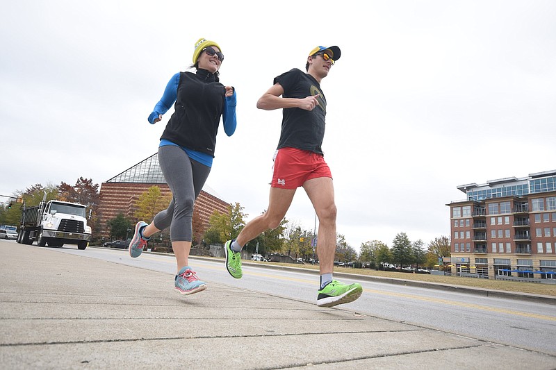 Stacey and Mark Malecky run along Riverfront Parkway Tuesday in preparation for Thursday's Thanksgiving race.