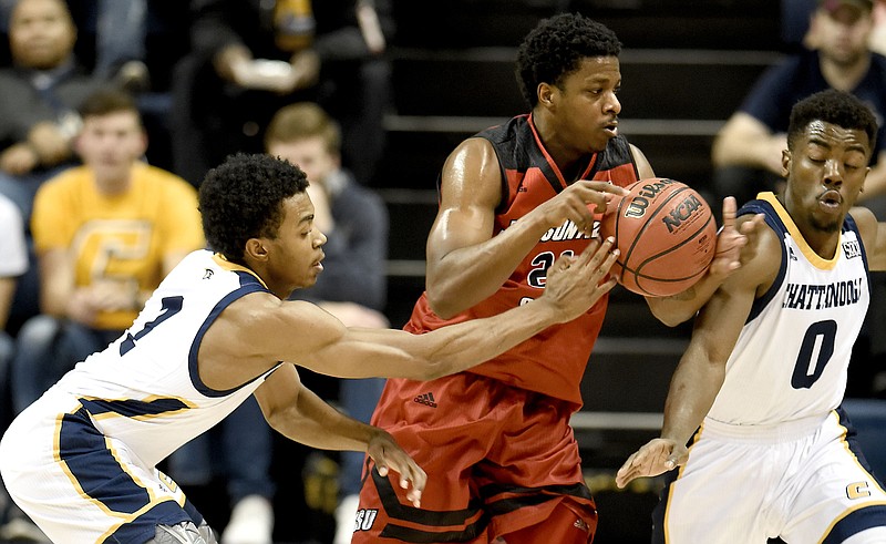 UTC's Rodney Chatman (1) knocks the ball away from Jacksonville's Malcolm Drumwright (21) while Makale Foreman (0) also applies pressure.  The Jacksonville State Gamecocks visited the University of Tennessee at Chattanooga Mocs in the Cayman Islands Classic Chattanooga Bracket at McKenzie Arena on November 21, 2017.