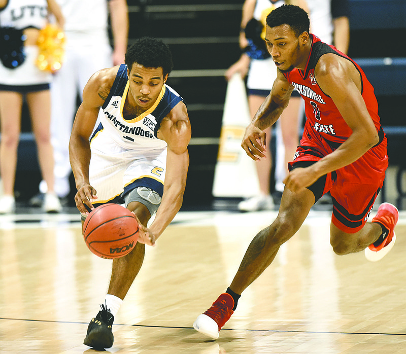 UTC's Rodney Chatman (1) gathers in a Jacksonville turnover as the Gamecock's Trey Christopher (0) pursues.  The Jacksonville State Gamecocks visited the University of Tennessee at Chattanooga Mocs in the Cayman Islands Classic Chattanooga Bracket at McKenzie Arena on November 21, 2017.
