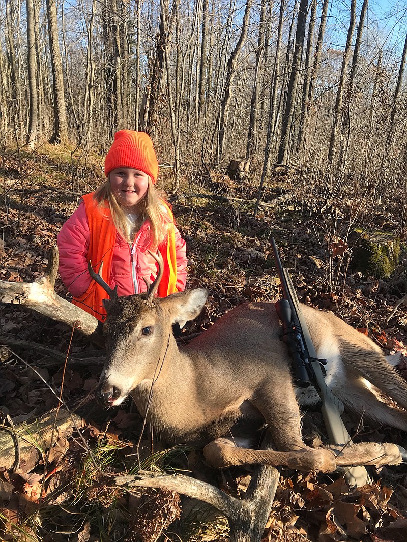 In this Nov. 19, 2017 photo provided by Tyler Harris, Lexie Harris, 6, poses after bagging a buck in Taylor County, Wis. Lexie is among the first youngsters to bag a buck under the state's new law that eliminates the state's minimum hunting age. She is no stranger to the woods. Her dad, Tyler Harris, has taken her hunting since she was three. But, it wasn't until Gov. Scott Walker signed the law on Nov. 12 that Lexie could legally shoot a deer. (Tyler Harris via AP)