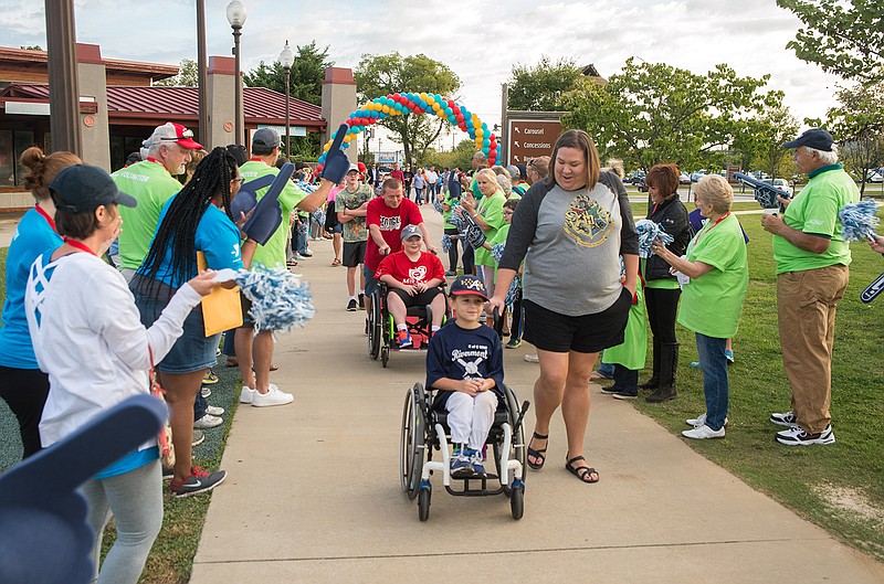 Fans welcome the players and their families as they enter the park.