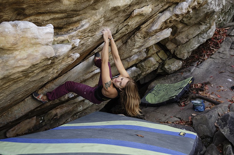 Sabine Connors climbs a boulder at Stone Fort, also known as Little Rock City, on Tuesday, Nov. 14, 2017, in Soddy-Daisy, Tenn. The fall and winter are peak times for climbers thanks to the region's generally mild climate.