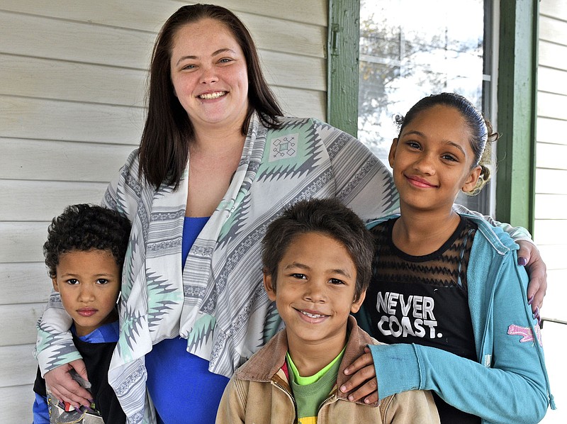 Ashley Osborne, 27, stands with her chilldren, from left, Regis Osborne, 6; Daemeon Cooke, 7; and Nevaeh Osborne, 11, at their Chattanooga home on Nov. 19, 2017.  The Osborne's received help from the Chattanooga Times Free Press Neediest Cases fund to repair their car.  