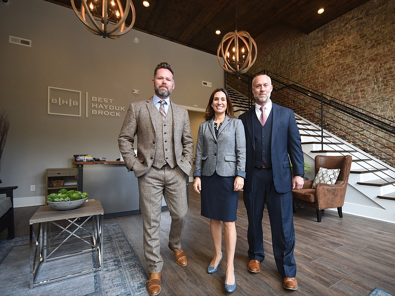 From left, Attorneys Matt Brock, Andrea Hayduk and Garth Best stand in their new offices at 1257 Market St. on Chattanooga's Southside.