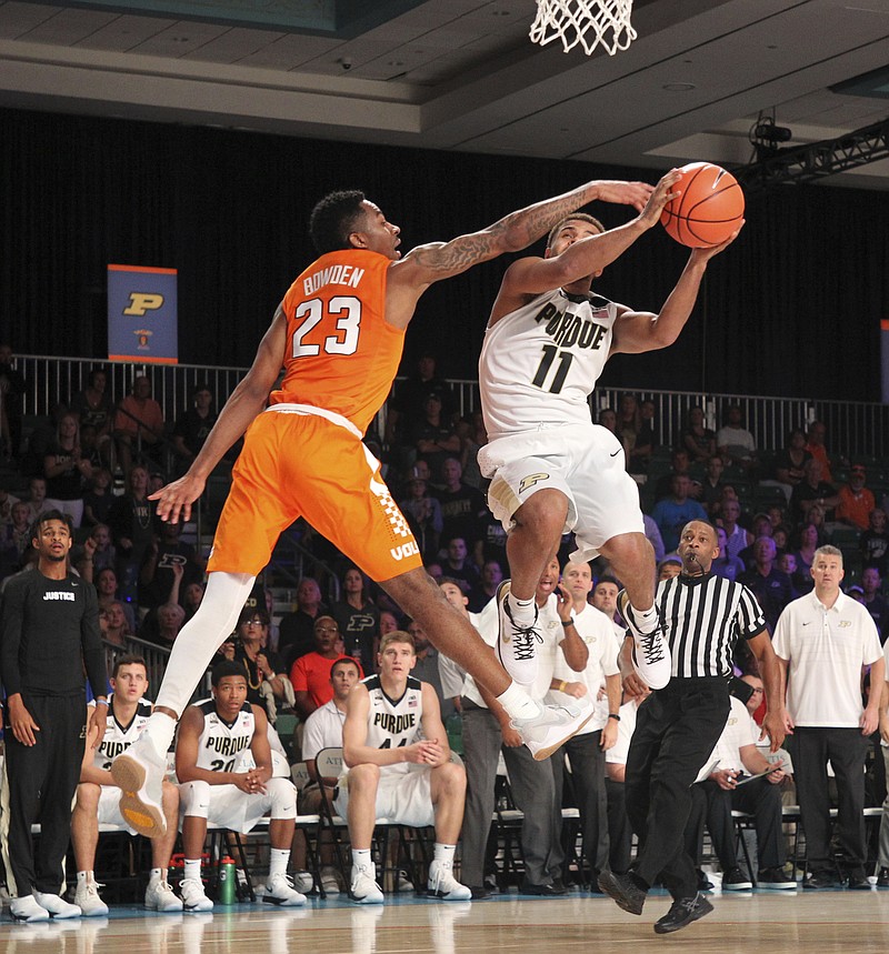 Purdue guard P.J. Thompson (11) drives to the basket guarded by Tennessee guard Jordan Bowden (23) during an NCAA college basketball game Wednesday, Nov. 22, 2017 in the Bad Boy Mowers Battle 4 Atlantis tournament in Paradise Island, Bahamas. (Tim Aylen/Bahamas Visual Services via AP)