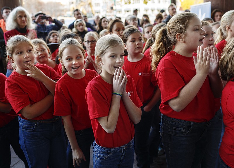 Children with the Chattanooga Girls Choir react as EPB's holiday window displays are unveiled at their Martin Luther King Jr. Boulevard headquarters on Wednesday, Nov. 22, 2017, in Chattanooga, Tenn. The displays can be viewed in the street-level windows on the Market Street side of the building.