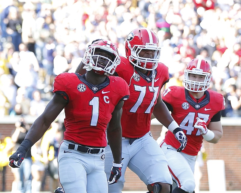 Georgia tailback Sony Michel (1), offensive lineman Isaiah Wynn (77) and fullback Christian Payne (47) celebrate during the 13-7 win at Georgia Tech in 2015.