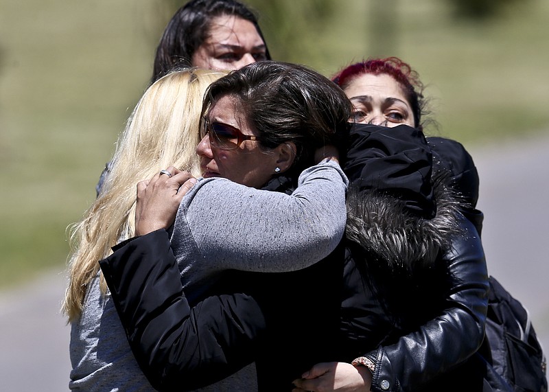 Relatives of missing submarine crew member Celso Oscar Vallejo, react to the news that a sound detected during the search for the ARA San Juan submarine is consistent with that of an explosion, at the Mar de Plata Naval Base in Argentina, Thursday, Nov. 23, 2017. A Navy spokesman said that the relatives of the crew have been informed and that the search will continue until there is full certainty about the fate of the submarine. He said there was no sign the explosion might be linked to any attack on the sub. (AP Photo/Esteban Felix)