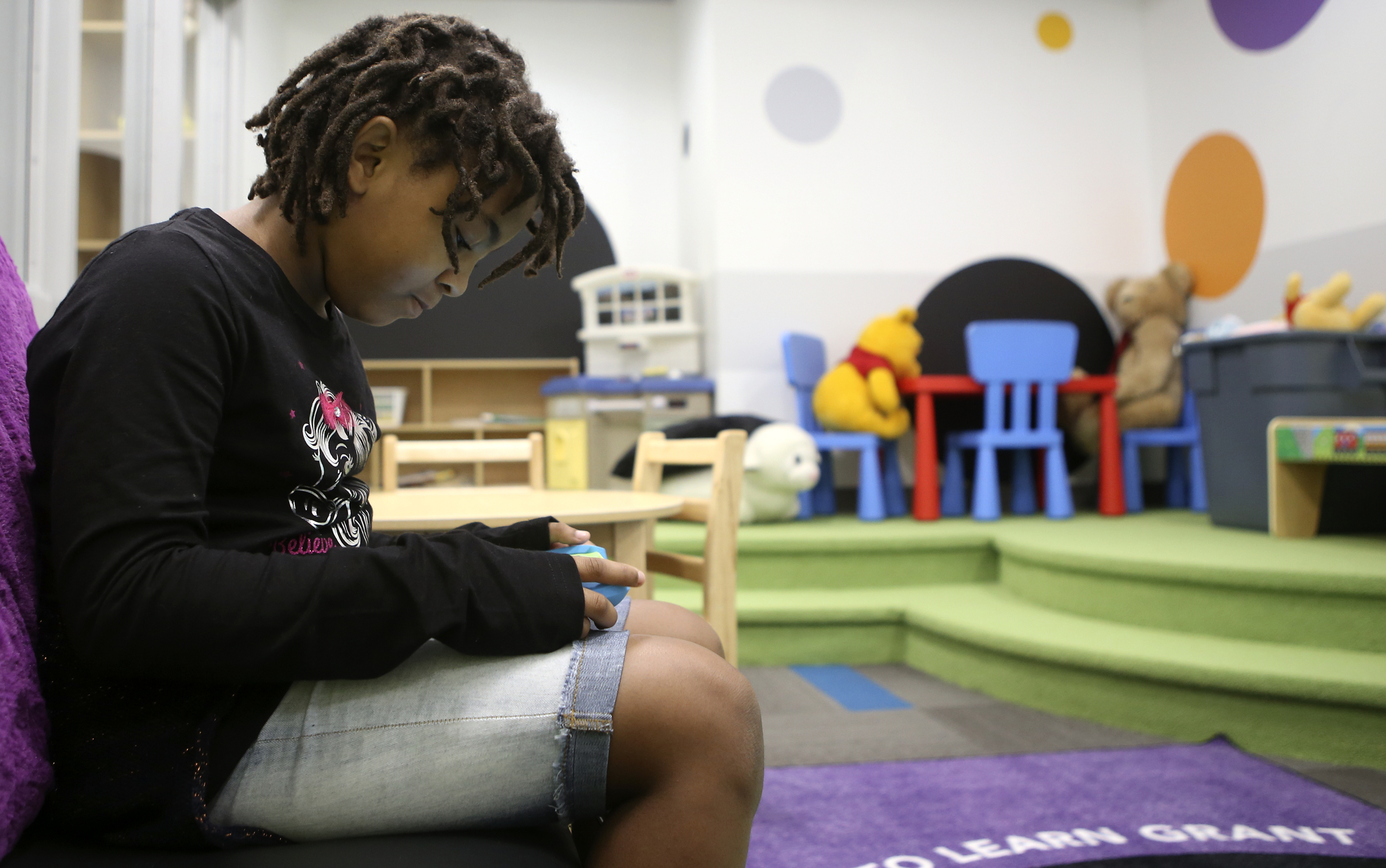 Nine-year-old Mikayla Sanders plays on a tablet while checking out the PBS KIDS Learning Lounge at the Family Justice Center on Thursday, Nov. 9, 2017 in Chattanooga, Tenn. The Learning Lounge offers a fun area for children to use while in a waiting room.