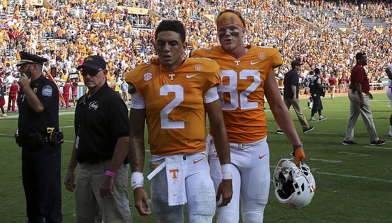 Tennessee tight end Ethan Wolf (82) exits the field with quarterback Jarrett Guarantano after the Vols' loss to South Carolina.