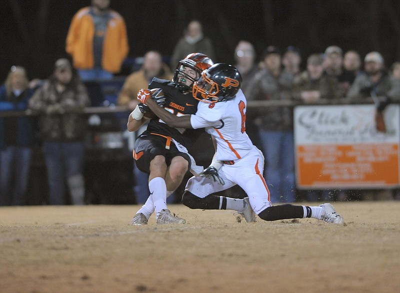 South Pittsburg's Curtavian Whisnant, right, tackles Greenback's Holden Willis on a punt return Friday night in a Class 1A semifinal at Greenback.