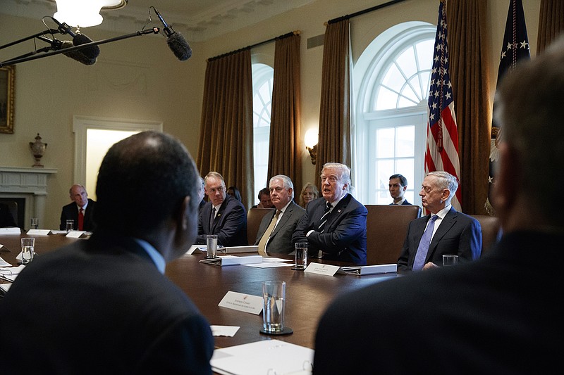 In this Oct. 16, 2017, file photo President Donald Trump speaks during a cabinet meeting at the White House in Washington, with from left, Director of National Intelligence Dan Coats, Interior Secretary Ryan Zinke, Secretary of State Rex Tillerson, and Defense Secretary Jim Mattis. The White House has already begun work on one of Trump's next priorities: welfare reform. He said changes were "desperately needed in our country" and that his administration would soon offer plans. In October, Trump said at a Cabinet meeting that welfare reform was "becoming a very, very big subject, and people are taking advantage of the system." (AP Photo/Evan Vucci)