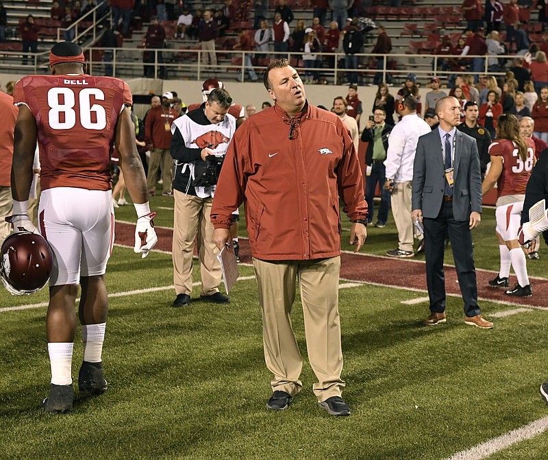 Arkansas coach Bret Bielema waits for his team to leave the field after their loss to Missouri in an NCAA college football game Friday, Nov. 24, 2017 in Fayetteville, Ark. (AP Photo/Michael Woods)
