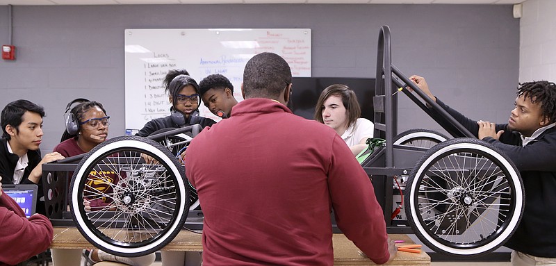 Japho Hardin, center, works with his students Wilmer Perez, left, Hayle' Mack, Chanel Lockett, Deunta Sailes, Cody Sowers and Marquez Williams on troubleshooting the wiring on the taillight for their electric car in the VW eLab at Howard School on Tuesday, Nov. 21, 2017 in Chattanooga, Tenn. Students in Hardin's Introduction to Engineering and Design class, made up of juniors, built an electric car using a kit from local nonprofit green | spaces to compete against other schools.
