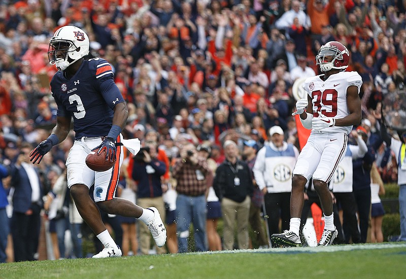 Auburn wide receiver Nate Craig-Myers scores a touchdown against Alabama defensive back Levi Wallace during the first half of the Iron Bowl NCAA college football game, Saturday, Nov. 25, 2017, in Auburn, Ala. (AP Photo/Brynn Anderson)