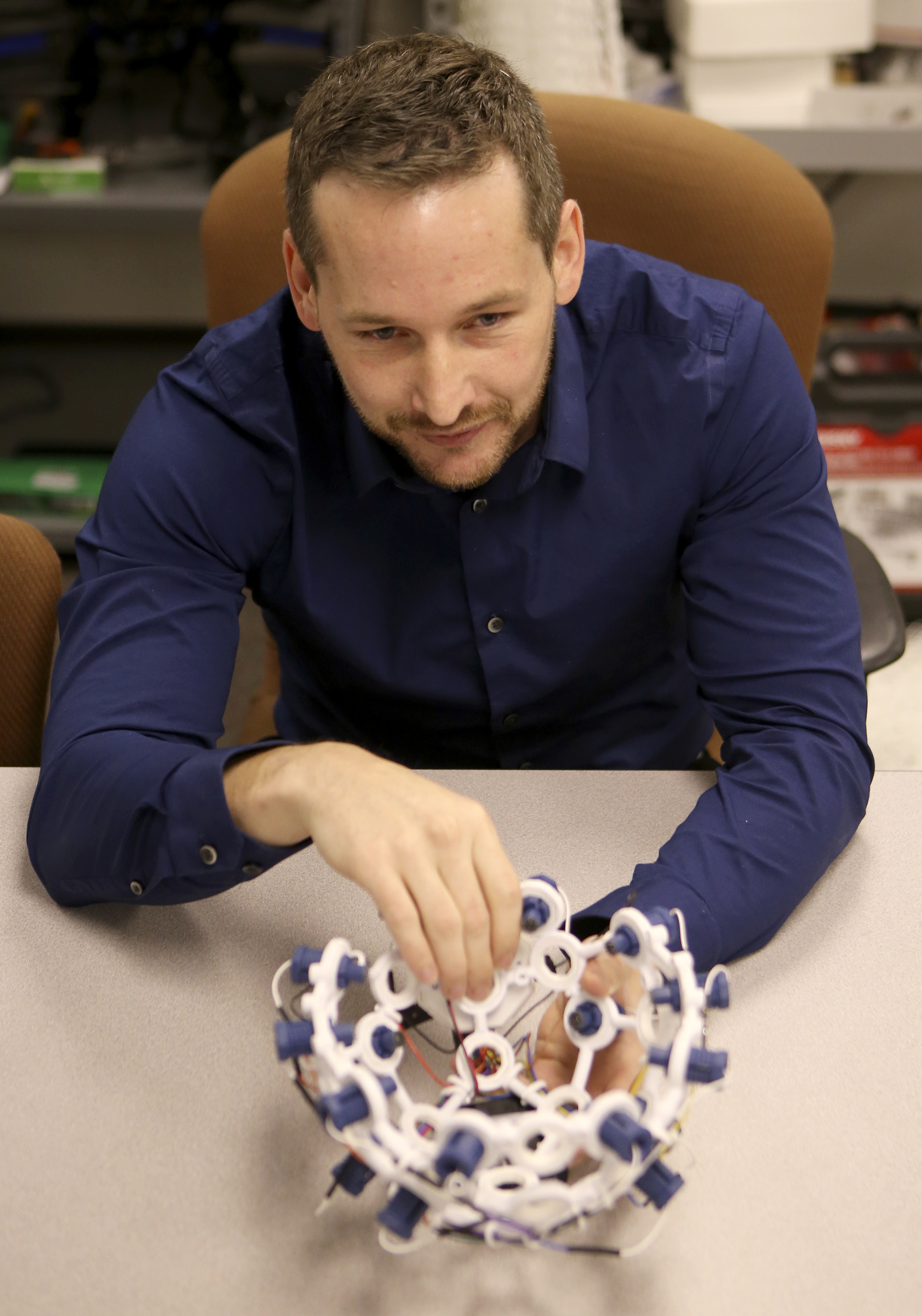 College of Engineering and Computer Science Postdoctoral Fellow Zachary Ruble talks about the process of using brainwaves to control a drone in the SimCenter on the campus of the University of Tennessee at Chattanooga on Tuesday, Nov. 21, 2017 in Chattanooga, Tenn. Sixteen sensors, reading different parts of the brain, detect electrical impulses in the user to trigger commands for the drone.