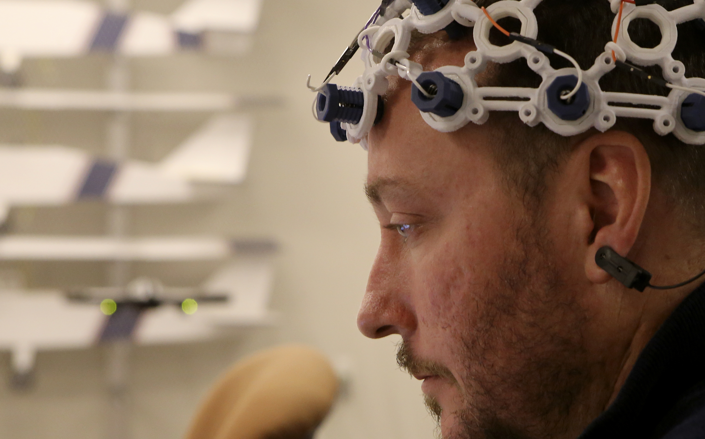 UTC senior Tony Ferguson, an electrical engineering major, launches a drone using his brain in the SimCenter on the campus of the University of Tennessee at Chattanooga on Tuesday, Nov. 21, 2017 in Chattanooga, Tenn. Sixteen sensors, reading different parts of the brain, detect electrical impulses in the user to trigger commands for the drone.