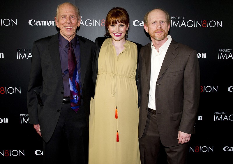 FILE - In this Nov. 15, 2011 file photo, Ron Howard, right, his daughter Bryce Dallas Howard and his father Rance Howard attend the premiere of "When You Find Me," inspired by Canon's "Project Imagin8ion" contest, in New York.