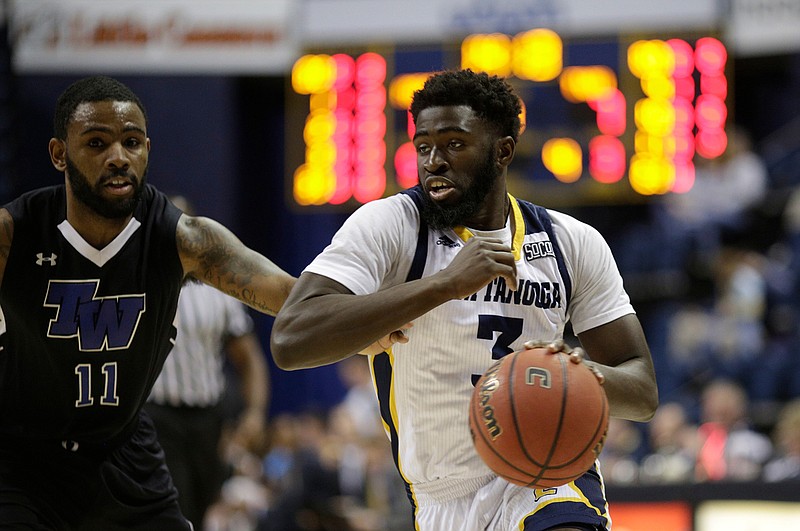 UTC guard David Jean-Baptiste dribbles around Tennessee Wesleyan's Aundre Reid during Saturday night's game at McKenzie Arena. Jean-Baptiste, a redshirt freshman, has become one of the Mocs' most consistent players.