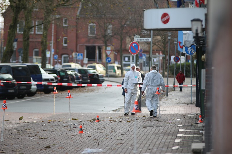 
              Police investigators look for traces after an apparently intoxicated man has driven a car into pedestrians in northern Germany city of Cuxhaven, Sunday morning, Nov. 26, 2017. Six people were injured. (Jens Potschka/Cuxhavener Nachrichten/dpa via AP)
            