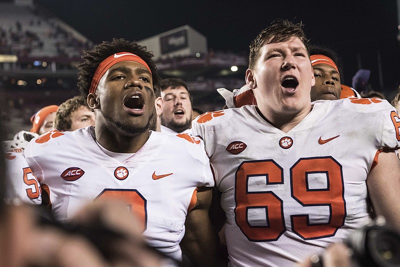 Clemson quarterback Kelly Bryant (2) and teammate Maverick Morris (69) celebrate after an NCAA college football game against South Carolina on Saturday, Nov. 25, 2017, in Columbia, S.C. Clemson defeated South Carolina 34-10. (AP Photo/Sean Rayford)