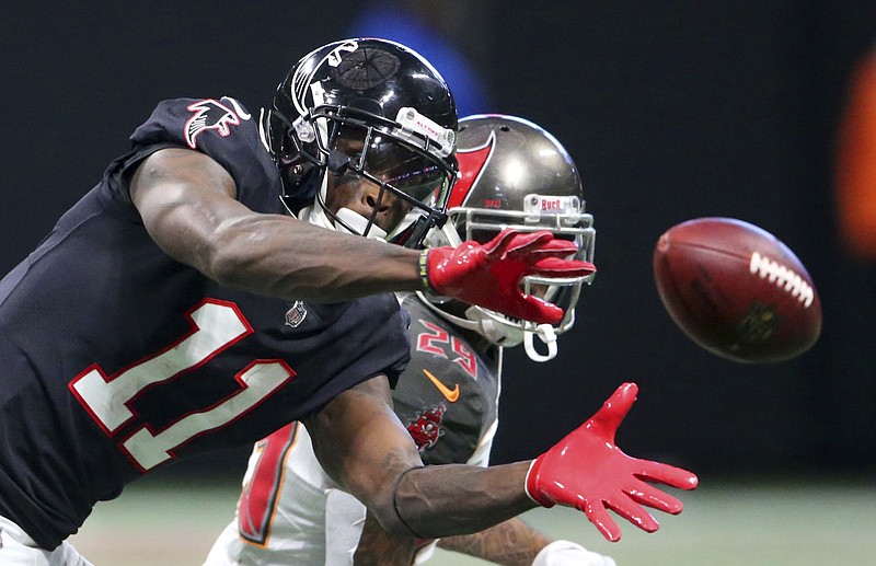 Atlanta Falcons wide receiver Julio Jones (11) makes the catch ahead of Tampa Bay Buccaneers cornerback Ryan Smith (29) during the second half of an NFL football game, Sunday, Nov. 26, 2017, in Atlanta. (AP Photo/John Bazemore)