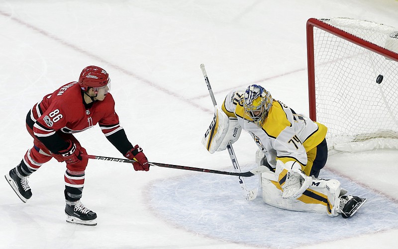 Carolina Hurricanes' Teuvo Teravainen (86), of Finland, scores against Nashville Predators goalie Juuse Saros (74), also of Finland, during a shootout in an NHL hockey game in Raleigh, N.C., Sunday, Nov. 26, 2017. (AP Photo/Gerry Broome)