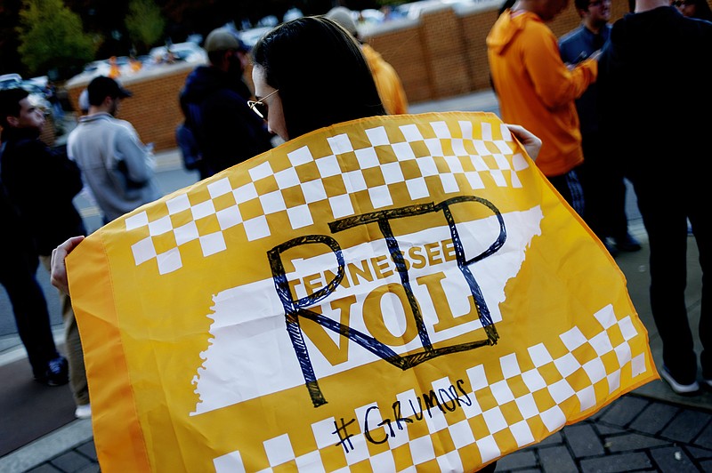 University of Tennessee freshman Morgan Morton waves a Tennessee Vol flag reading "RIP" during a gathering of Tennessee fans reacting to the possibility of hiring Ohio State defensive coordinator Greg Schiano for its head coaching vacancy Sunday, Nov. 26, 2017, in Knoxville, Tenn. (Calvin Mattheis/Knoxville News Sentinel via AP)