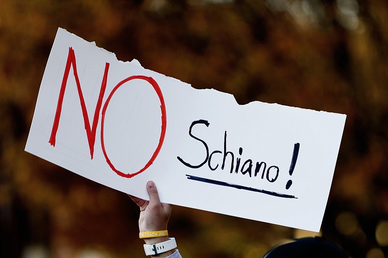 A Tennessee fan holds a sign reading "No Schiano!" during a gathering of Tennessee fans reacting to the possibility of hiring Ohio State defensive coordinator Greg Schiano for its head coaching vacancy Sunday, Nov. 26, 2017, in Knoxville, Tenn. (Calvin Mattheis/Knoxville News Sentinel via AP)