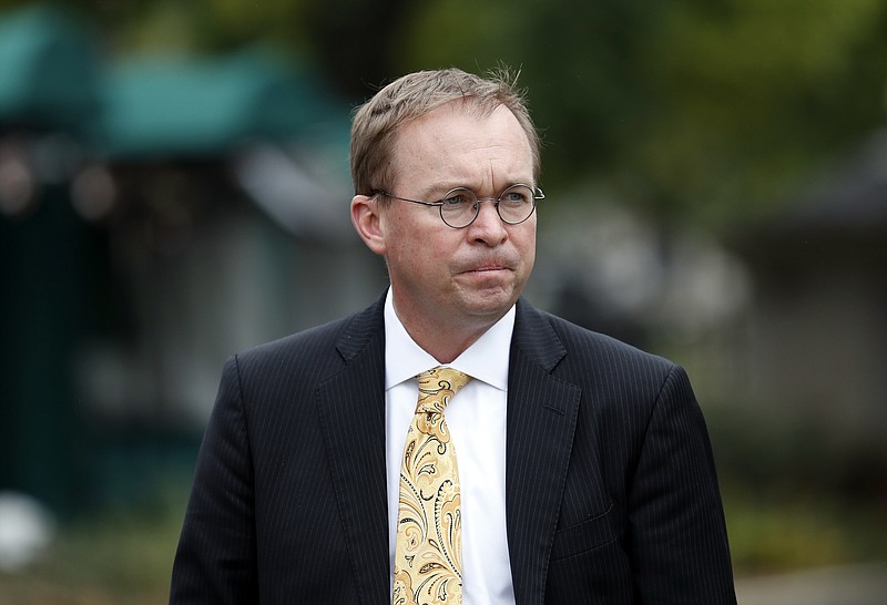 In this Sept. 13, 201, file photo, Director of the Office of Management and Budget Mick Mulvaney departs after a television interview at the White House in Washington. Senior Trump administration officials said Saturday, Nov. 25, that they expect no trouble when President Donald Trump's pick for temporary director of the Consumer Financial Protection Bureau shows up for work, despite the clash on who should take over. Trump announced he was picking Mulvaney within a few hours of Richard Cordray's announcement on Friday. (AP Photo/Alex Brandon, File)