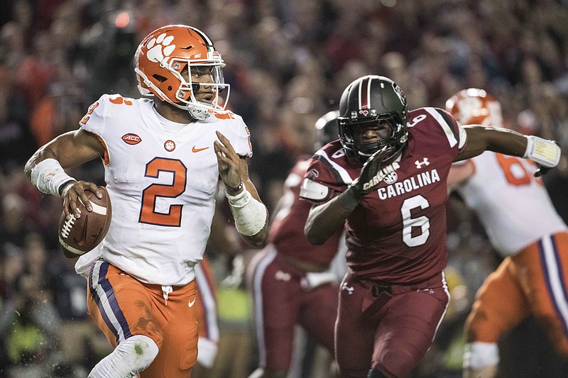 Clemson quarterback Kelly Bryant (2) scrambles from the pocket against South Carolina linebacker T.J. Brunson (6) during the first half of an NCAA college football game Saturday, Nov. 25, 2017, in Columbia, S.C. Clemson defeated South Carolina 34-10. (AP Photo/Sean Rayford)