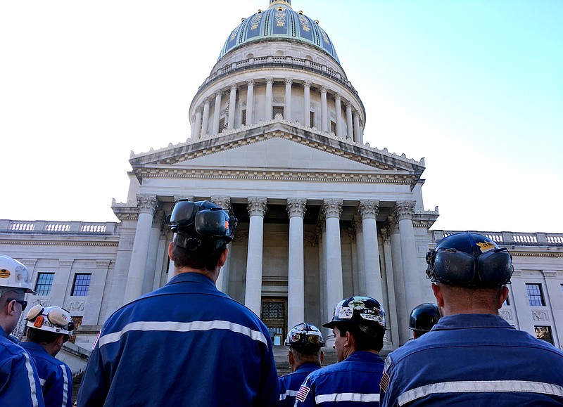 A group of coal miners listens to speakers at a pro-coal rally, Tuesday, Nov. 28, 2017, at the state Capitol in Charleston, W.Va. 