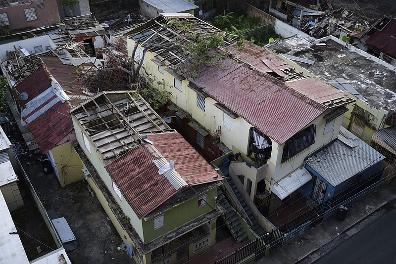 
              In this Nov. 15, 2017 photo, some roofs damaged by the whip of Hurricane Maria are still exposed to rainy weather conditions, in San Juan, Puerto Rico. A newly created Florida company with an unproven record won more than $30 million in contracts from the Federal Emergency Management Agency to provide emergency tarps and plastic sheeting for repairs to hurricane victims in Puerto Rico. Bronze Star LLC never delivered those urgently needed supplies, which even months later remain in demand on the island.  (AP Photo/Carlos Giusti)
            