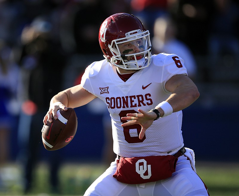 This photo taken Nov. 18, 2017, shows Oklahoma quarterback Baker Mayfield (6) during the first half of an NCAA college football game against Kansas in Lawrence, Kan. While the Sooners have already clinched a spot in the Big 12 championship game, they need to beat West Virginia to stay in the top four of the College Football Playoff rankings. (AP Photo/Orlin Wagner)