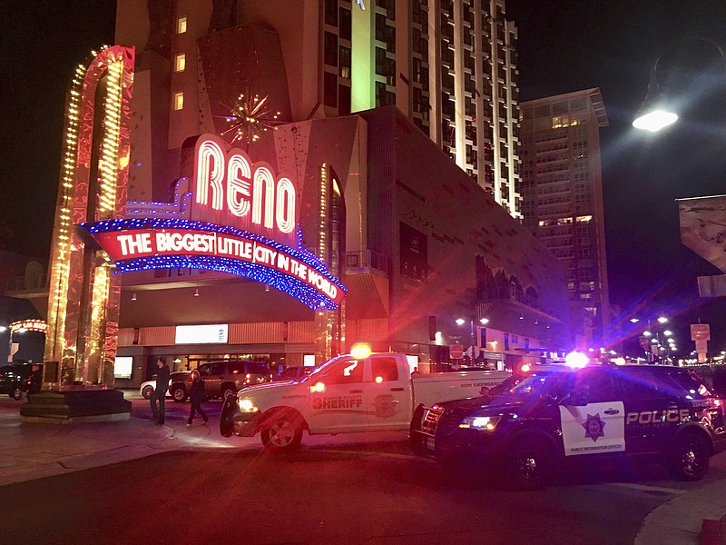 Police respond to an active shooter at a high-rise building of luxury condominiums in Reno, Nev., Tuesday, Nov. 28, 2017. A suspect is in custody after opening fire for at least 20 minutes Tuesday night, but there are no reports of any injuries, authorities said. The shots were fired at the Montage, a building in downtown Reno where SWAT teams and news vans have gathered. (Andy Barron/The Reno Gazette-Journal via AP)