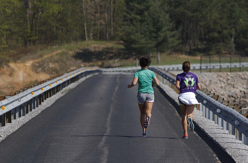 Meredith Piacentini and Sheena Mazgowan run around the Raccoon Mountain reservoir in this 2013 file photo.
