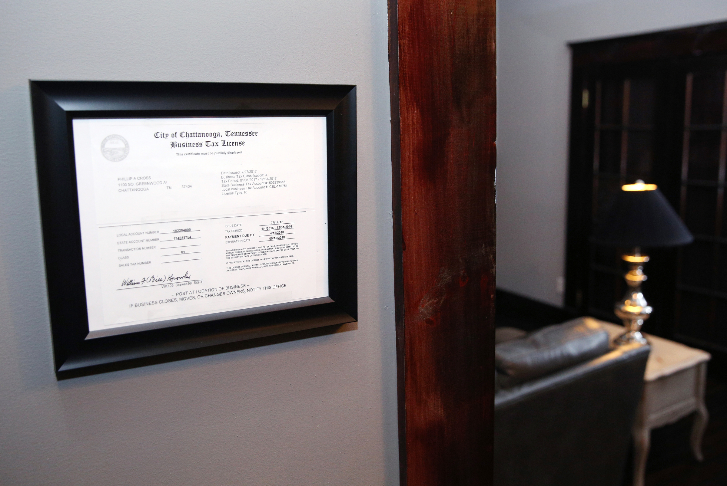 A business tax license is displayed at the entrance of Phil Cross's Airbnb home Wednesday, Nov. 29, 2017, in Chattanooga, Tenn. The Hamilton County Trustee's Office wants all Airbnb hosts to start paying taxes, and county officials have been able to track down some Airbnb hosts who aren't paying through a little detective work.