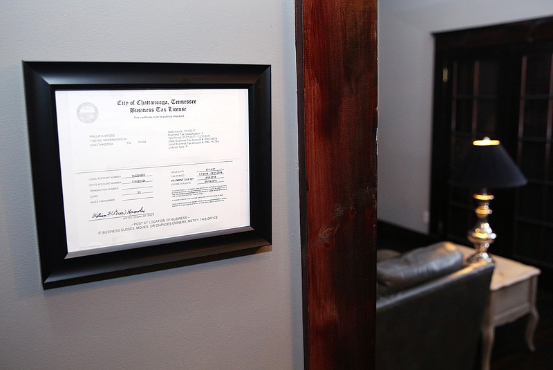 A business tax license is displayed at the entrance of Phil Cross's Airbnb home Wednesday, Nov. 29, 2017, in Chattanooga, Tenn. The Hamilton County Trustee's Office wants all Airbnb hosts to start paying taxes, and county officials have been able to track down some Airbnb hosts who aren't paying through a little detective work. 