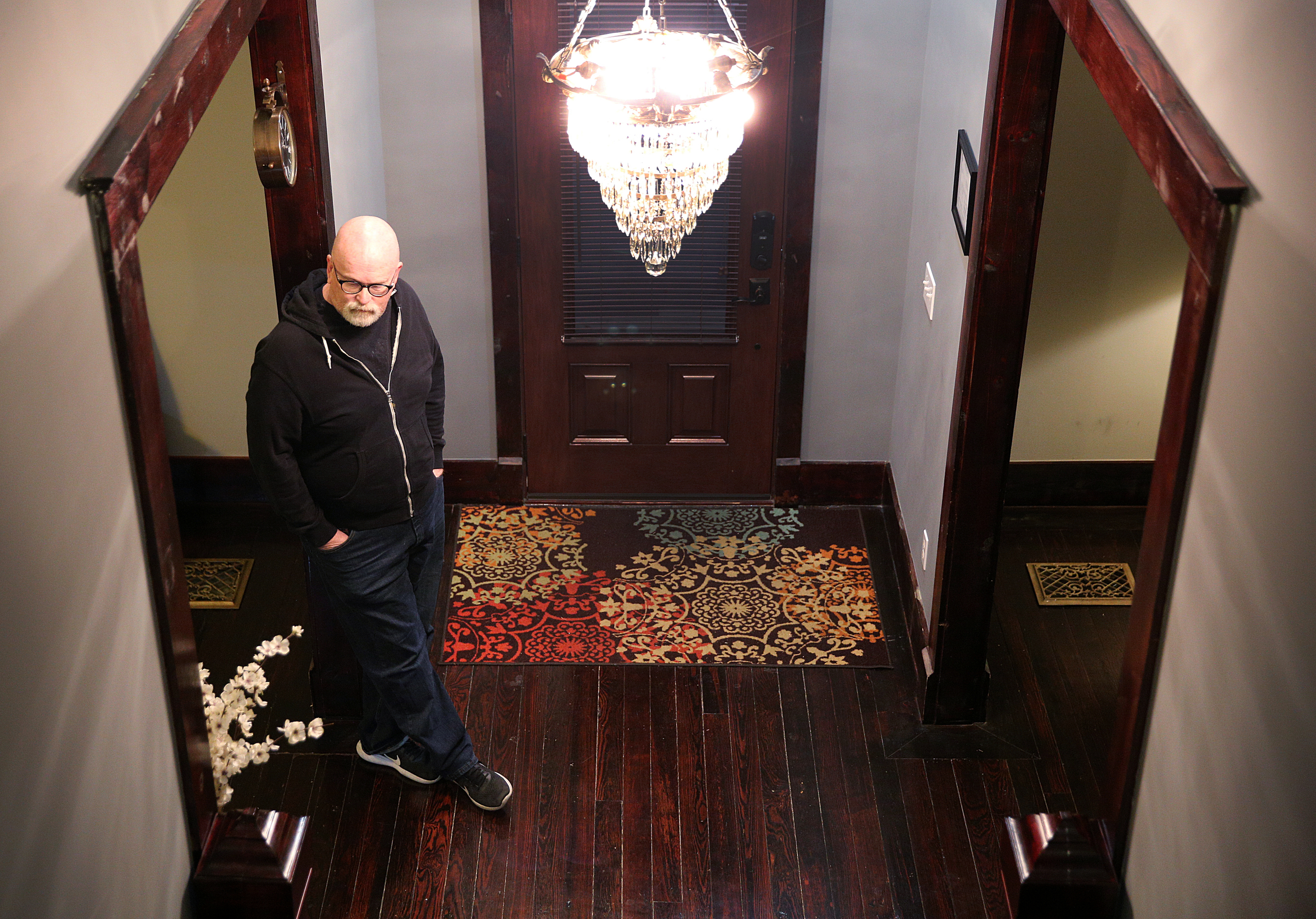 Phil Cross stands at the entrance of his home Wednesday, Nov. 29, 2017, in Chattanooga, Tenn. Cross thought it might help pay the electric bill when he decided two years ago to be an Airbnb host, but it has become more of a side business.
