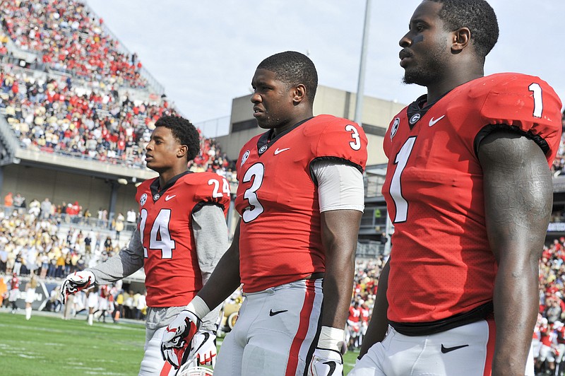 Georgia senior safety Dominick Sanders, junior inside linebacker Roquan Smith and senior running back Sony Michel head to midfield for the coin toss before last Saturday's 38-7 drubbing of Georgia Tech in Atlanta.