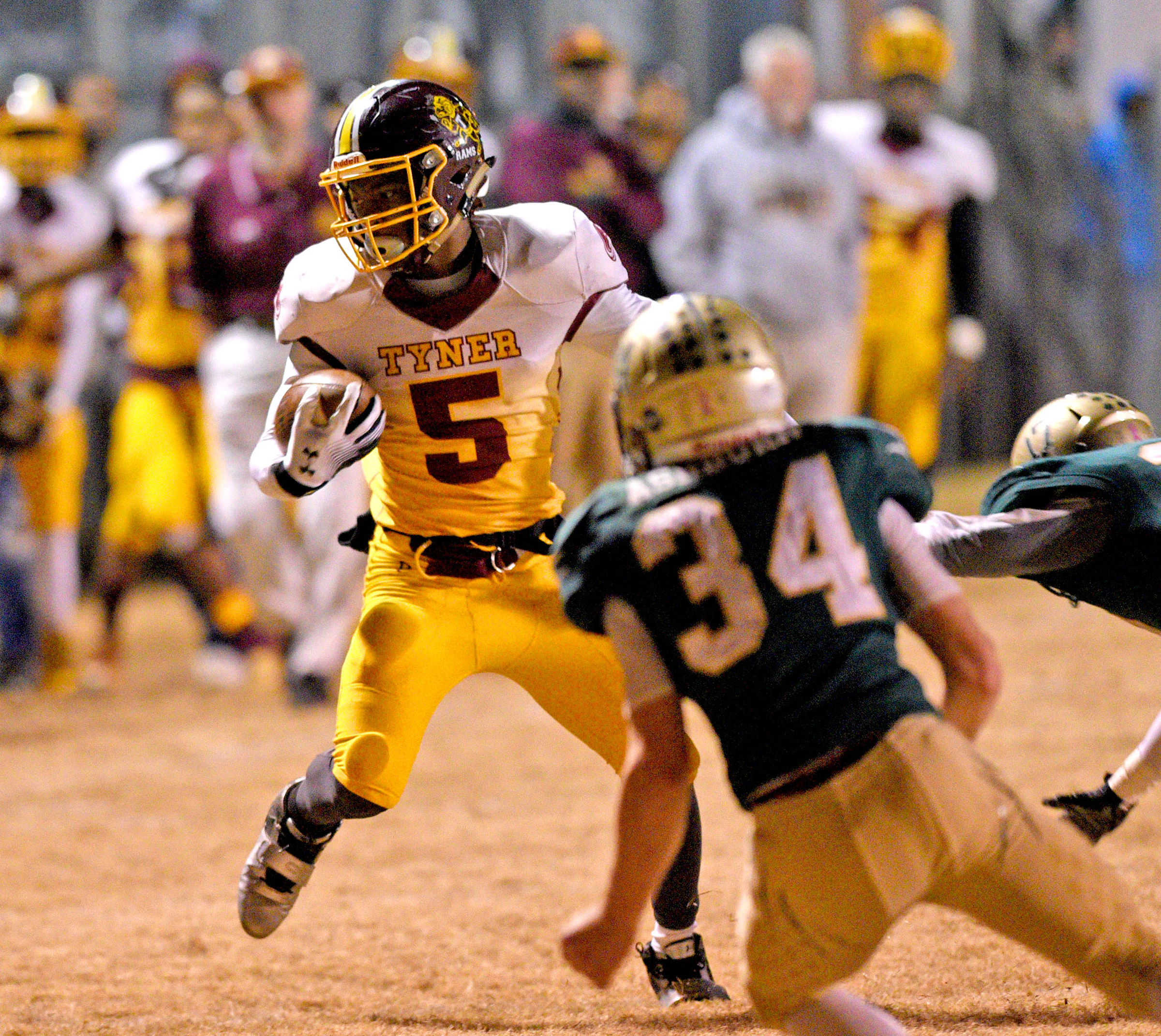 Tyner's Ke'un Webb (5) triest to shake off Tiger tacklers. The Tyner Rams visited the Rockwood Tigers in the semi-finals of the TSSAA Class AA Championship on November 24, 2017.