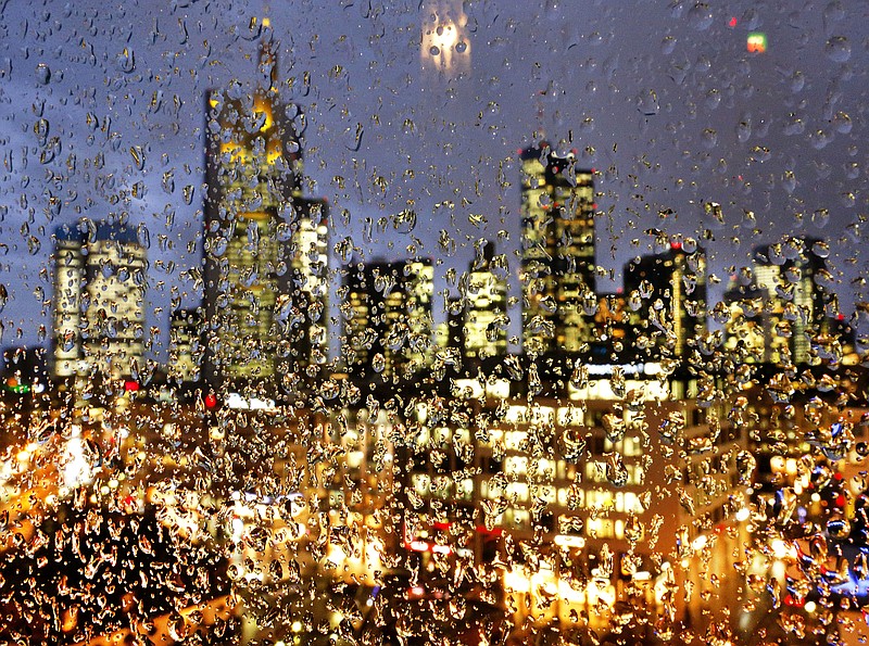 
              2017 AP YEAR END PHOTOS - The buildings of the banking district are seen through rain drops on a glass railing in central Frankfurt, Germany, on Jan. 11, 2017. (AP Photo/Michael Probst)
            