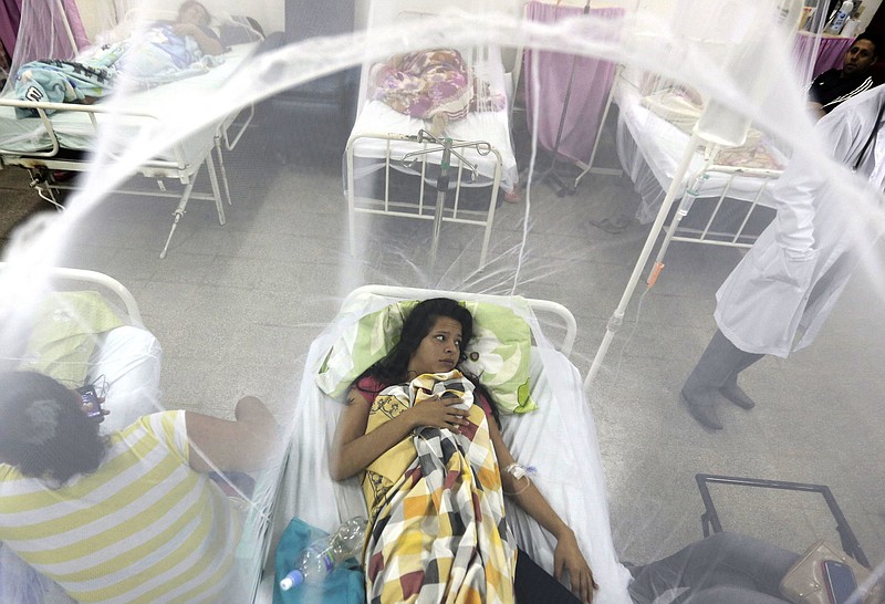 
              FILE - In this Friday, Feb. 5, 2016 file photo, Nadia Gonzalez, enclosed in a mosquito net, recovers from a bout of dengue fever at a hospital in Luque, Paraguay. Drugmaker Sanofi said Thursday, Nov. 30, 2017, that its dengue vaccine _ the world’s first _ could put people at risk of severe disease if they haven’t previously been infected, according to new long-term data. (AP Photo/Jorge Saenz, File)
            