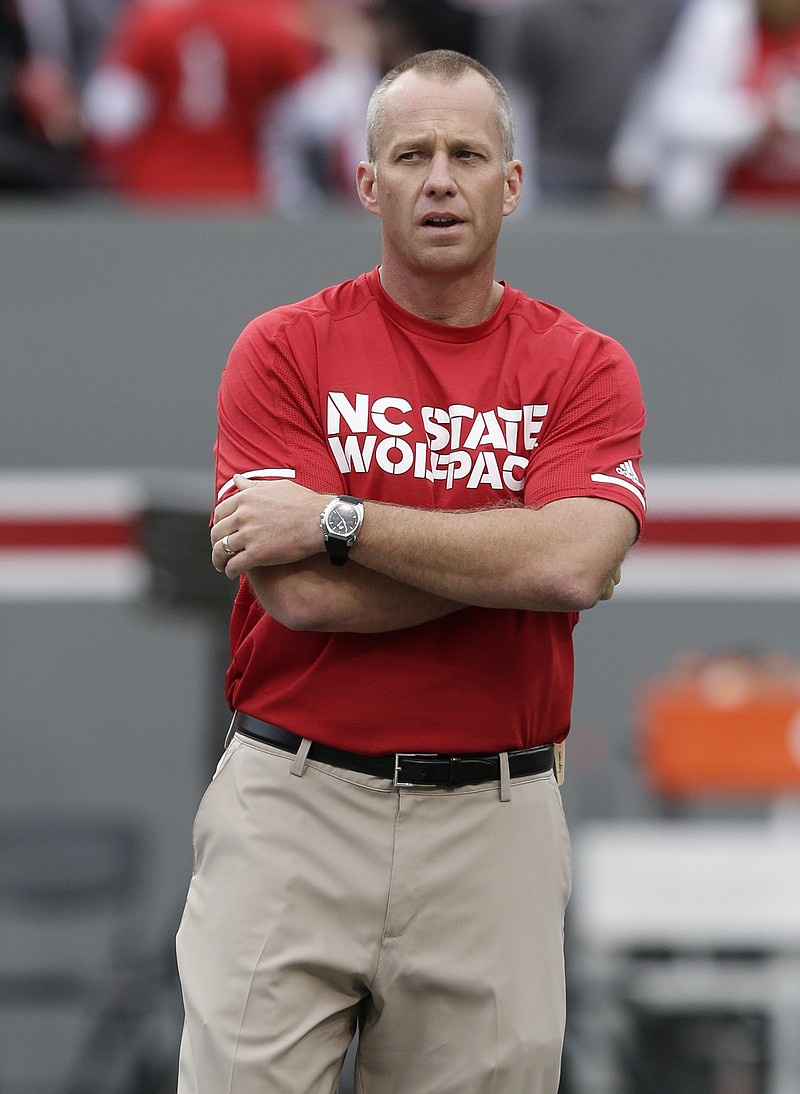 
              FILE- This Nov. 4, 2017, file photo shows North Carolina State head coach Dave Doeren watches prior to an NCAA college football game against Clemson in Raleigh, N.C.  With an Atlantic Coast Conference title no longer a possibility, No. 25 North Carolina State is refocusing on winning its version of a state championship. The Wolfpack wrap up the regular season with two games against annual instate rivals, starting Saturday night at Wake Forest and concluding next week with a visit from North Carolina. (AP Photo/Gerry Broome, File)
            