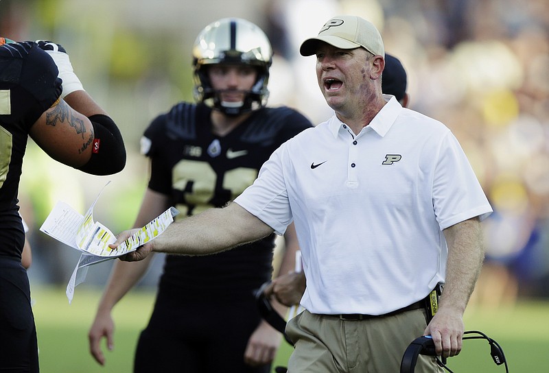 In this Sept. 23, 2017, file photo, Purdue head coach Jeff Brohm yells to an official during the first half of an NCAA college football game against Michigan in West Lafayette, Ind. Indiana and Purdue head into their regular-season finale with the same Bucket list. Indiana plays Purdue on Saturday, Nov. 25, 2017. (AP Photo/Michael Conroy, File)